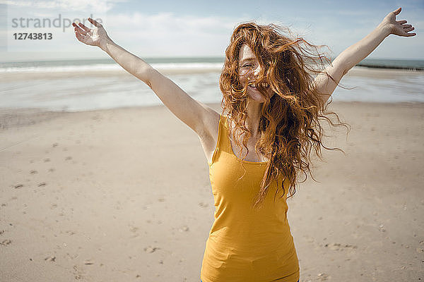 Redheaded woman  laughing happily in the wind
