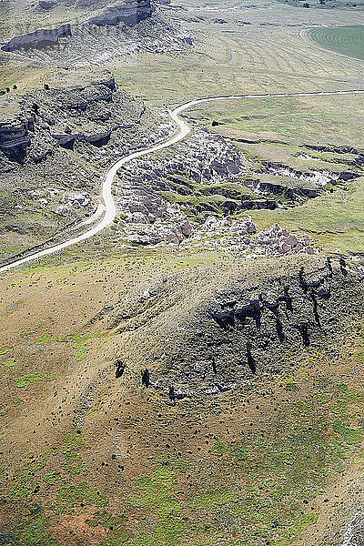 USA  Aerial of escarpments and cliffs bisected by a country road in Western Nebraska