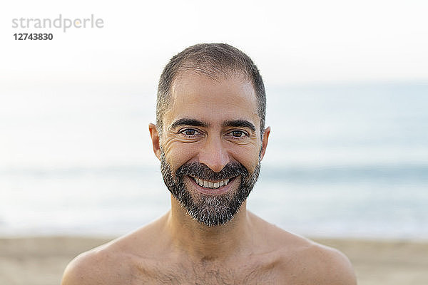 Portrait of happy man on a beach in the evening