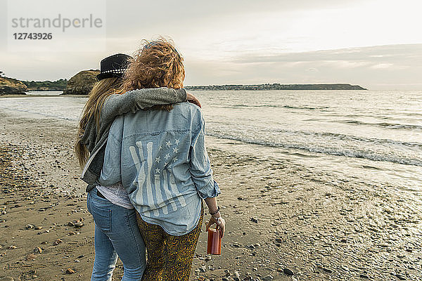 Best friends watching the sunset on the beach