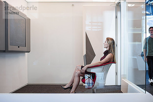 Businesswoman having a video conference in a cubicle