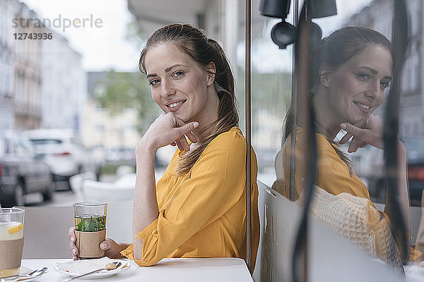 Woman sitting in coffee shop  drinking peppermint tea