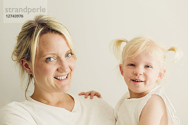 Portrait of smiling mother her little daughter