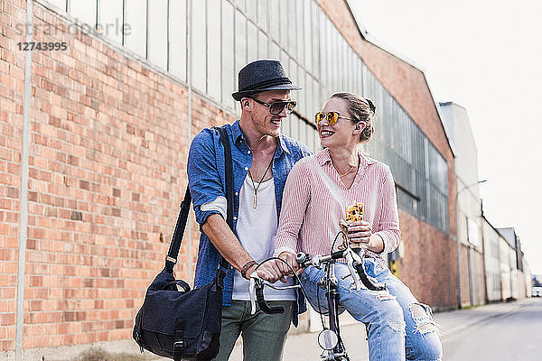 Young couple with bicycle on the street