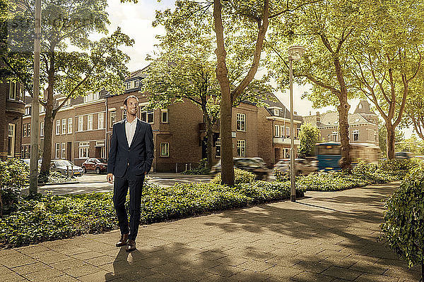 Netherlands  Venlo  confident businessman standing on pavement