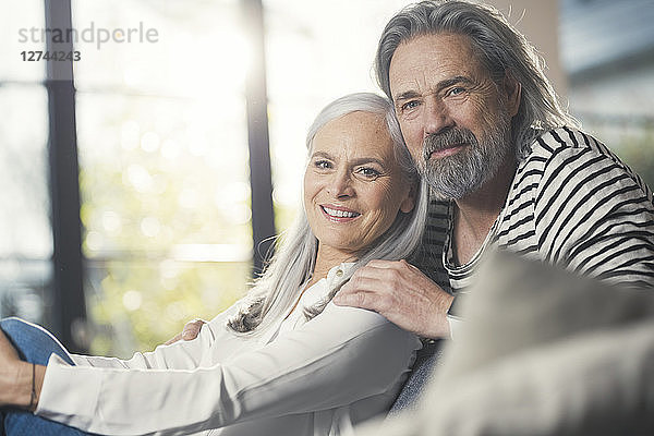 Happy senior couple sitting at home