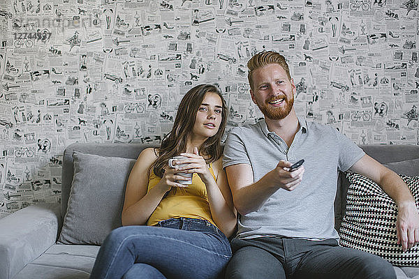 Couple sitting on couch watching TV