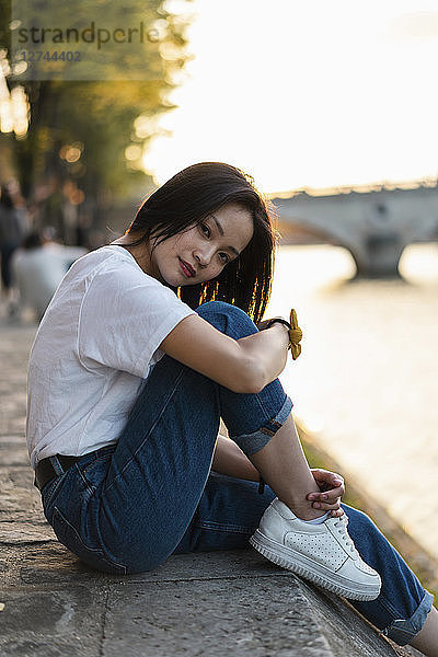 France  Paris  portrait of young woman at river Seine at sunset