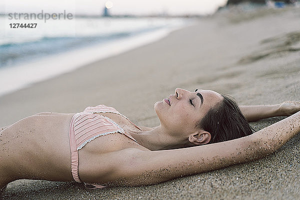 Beautiful woman lying on the beach