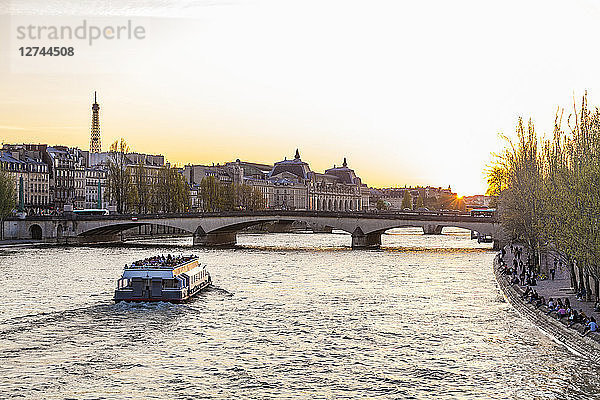 France  Paris  Pont du Carrousel with tourist boat at sunset