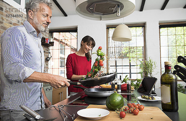 Couple in kitchen  preparing food toghether