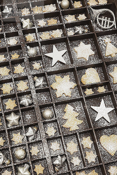 Homemade Christmas cookies  stars and Christmas baubles in old wooden typecase