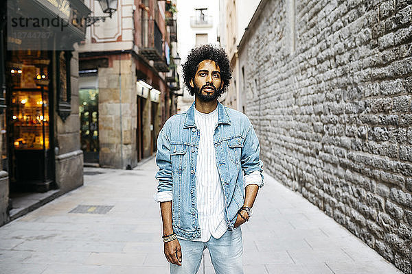 Spain  Barcelona  portrait of bearded young man with curly hair