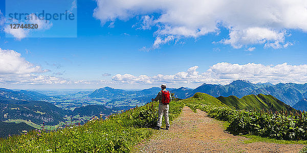 Germany  Allgaeu Alps  Hiker standing on path looking at panoramic road from Fellhorn to Sollereck mountain