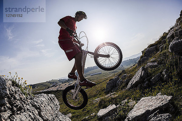 Acrobatic biker on trial bike