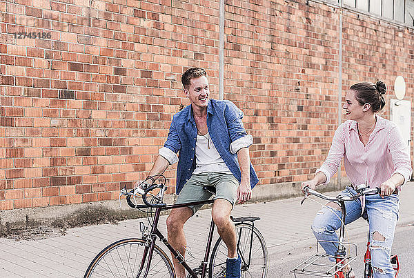 Young couple riding bicycle