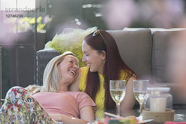 Affectionate lesbian couple relaxing on patio