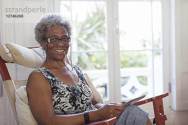 Portrait smiling  confident senior woman using digital tablet
