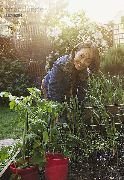Portrait smiling active senior woman gardening