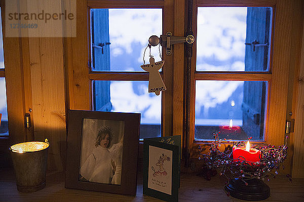 Weihnachtsschmuck und Kerze auf der Fensterbank