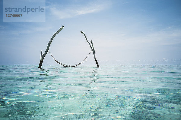 Ruhige Hängematte über dem idyllischen blauen Ozean  Malediven  Indischer Ozean