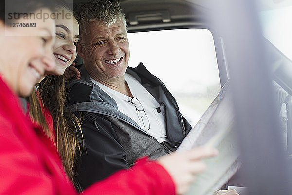 Eltern und Tochter betrachten die Karte im Wohnmobil