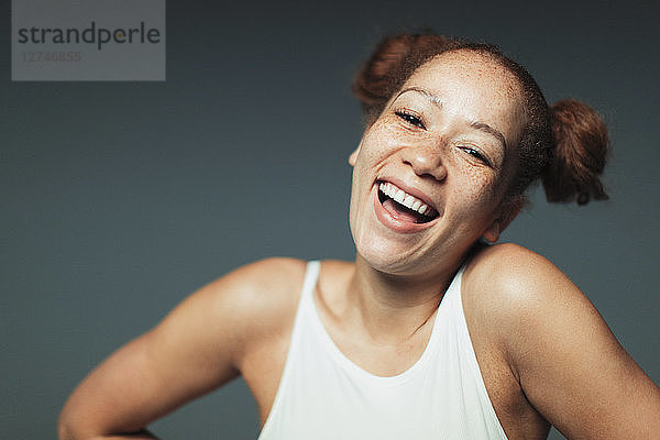 Portrait carefree woman with freckles laughing