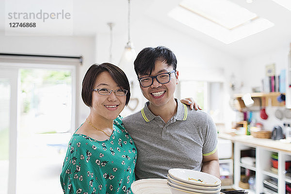 Portrait happy couple in kitchen