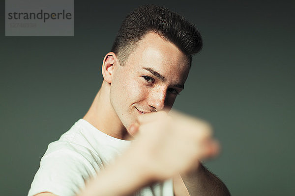 Portrait playful  cool teenage boy in fighting stance