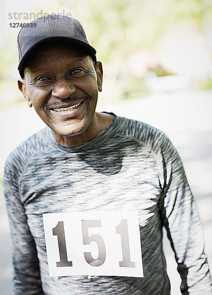 Portrait smiling  confident active senior man wearing sports race bib