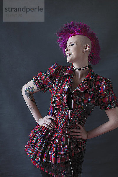Portrait confident young woman with pink mohawk