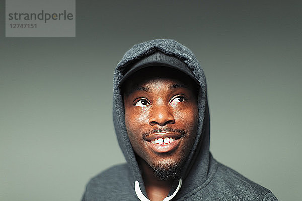 Portrait teenage boy in hoody looking up