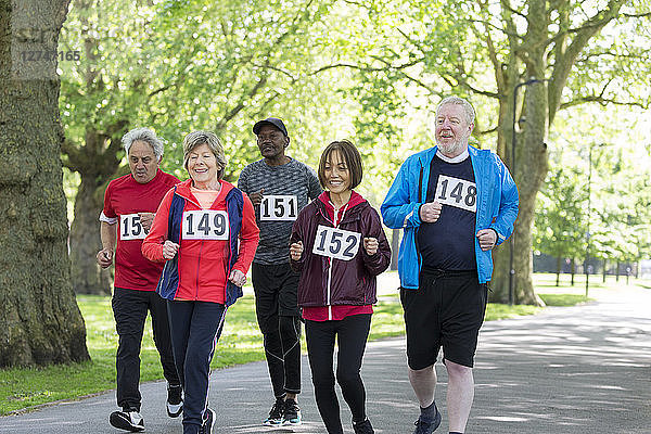 Active seniors power walking sports race in park