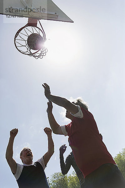 Active senior men playing basketball