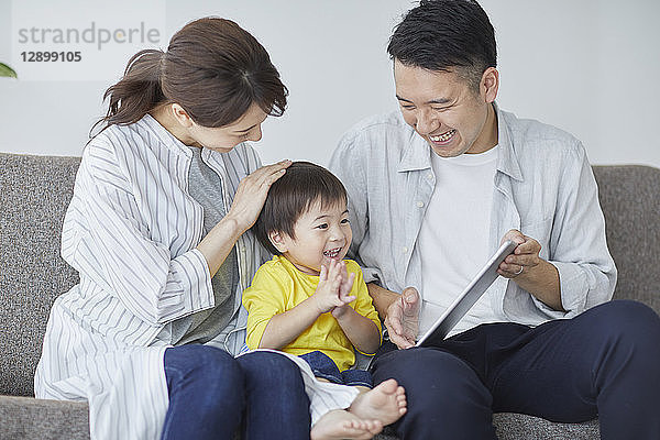 Japanische Familie auf dem Sofa