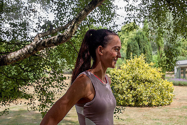 Frau praktiziert Yoga im Garten  macht eine Pause