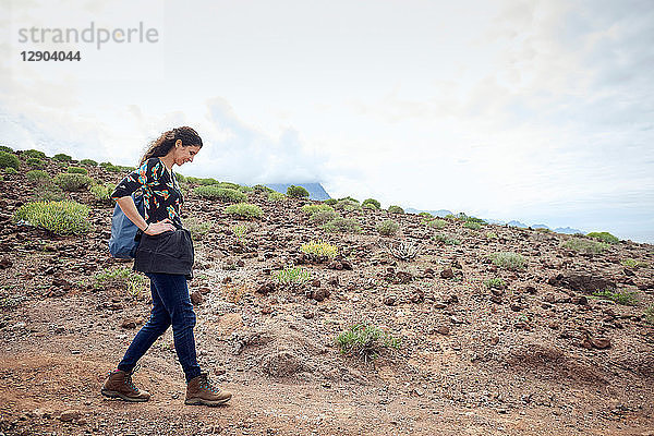 Frau wandert auf Feldwegen in trockener Landschaft  Las Palmas  Gran Canaria  Kanarische Inseln  Spanien
