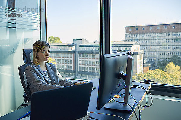 Businesswoman using computer in office