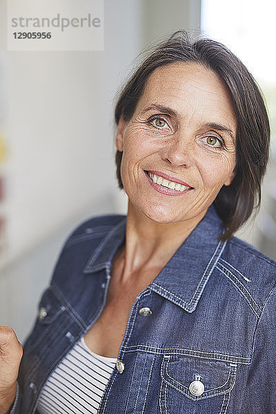 Portrait of smiling mature woman wearing denim shirt