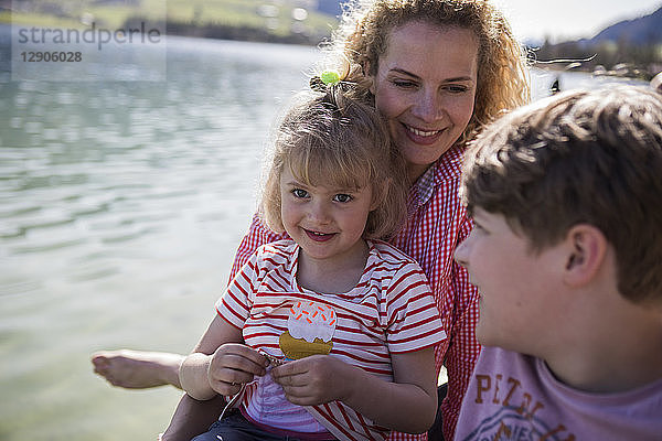 Austria  Tyrol  Walchsee  happy mother with two children at the lakeside