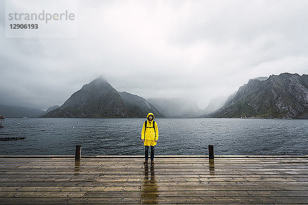 Norway  Lofoten  man standing on a pier at the coast