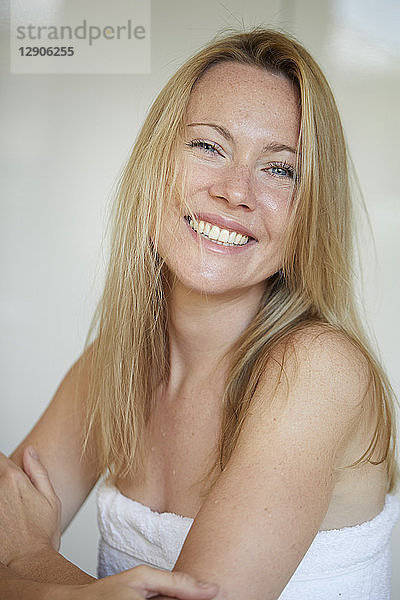 Portrait of a smiling woman  wrapped in towel