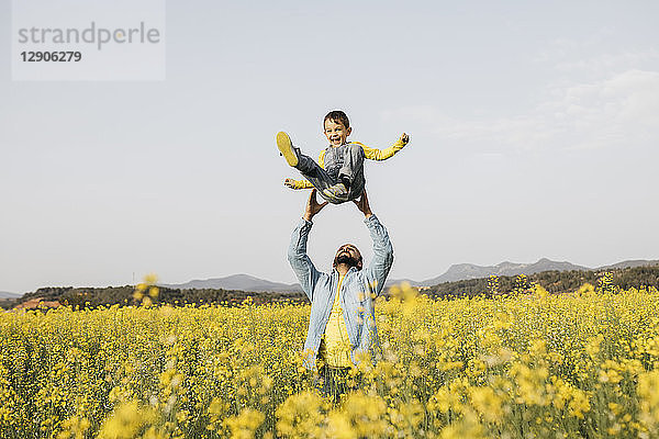 Spain  father and little son having fun together in a rape field