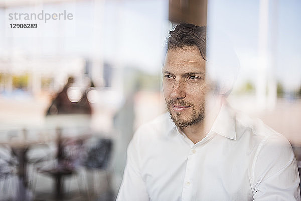 Portrait of businessman looking out of window