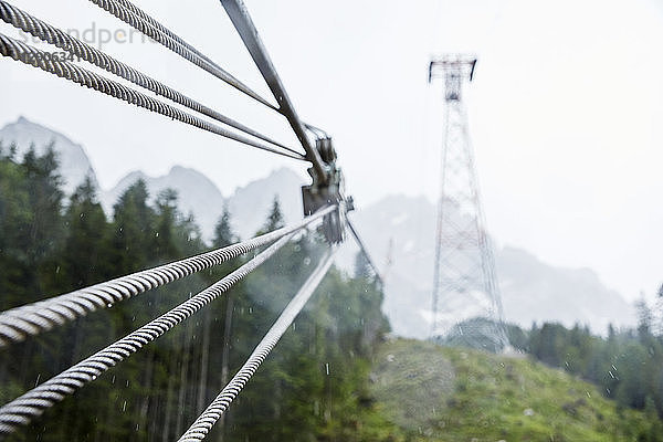 Germany  Bavaria  Garmisch-Partenkirchen  Zugspitze  steel rope of goods cable lift in rain
