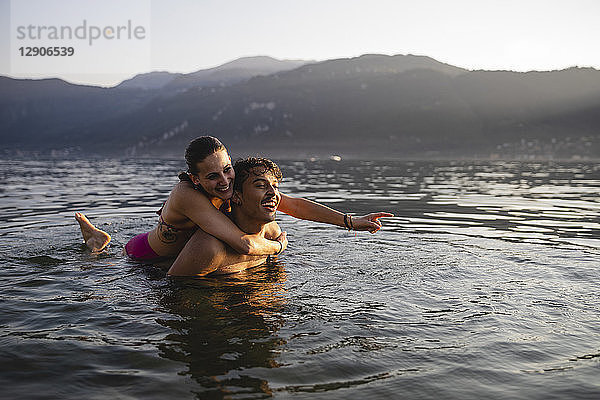 Happy carefree young couple in a lake