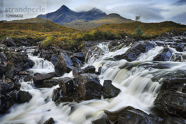 United Kingdom  Scotland  Scottish Highlands  Isle Of Skye  Waterfall at Sligachan river with view to the Cuillin mountains