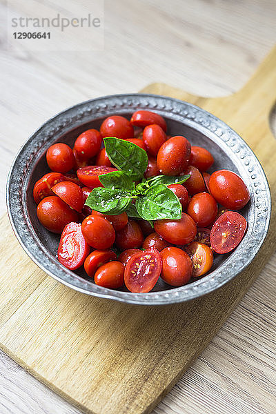Tomatoes and basil in zinc bowl