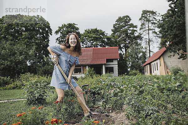 Portrait of happy woman working in garden