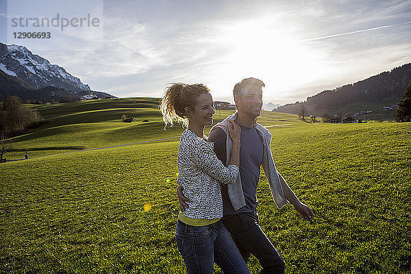 Austria  Tyrol  Walchsee  happy couple hiking on an alpine meadow